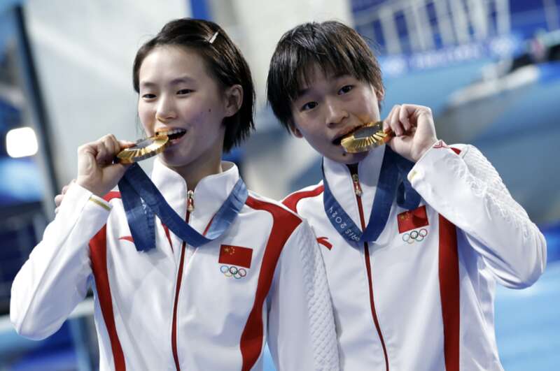 A couple of people eating medals
        Description automatically generated